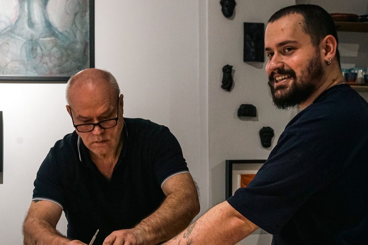Two craftsmen working together at a workbench