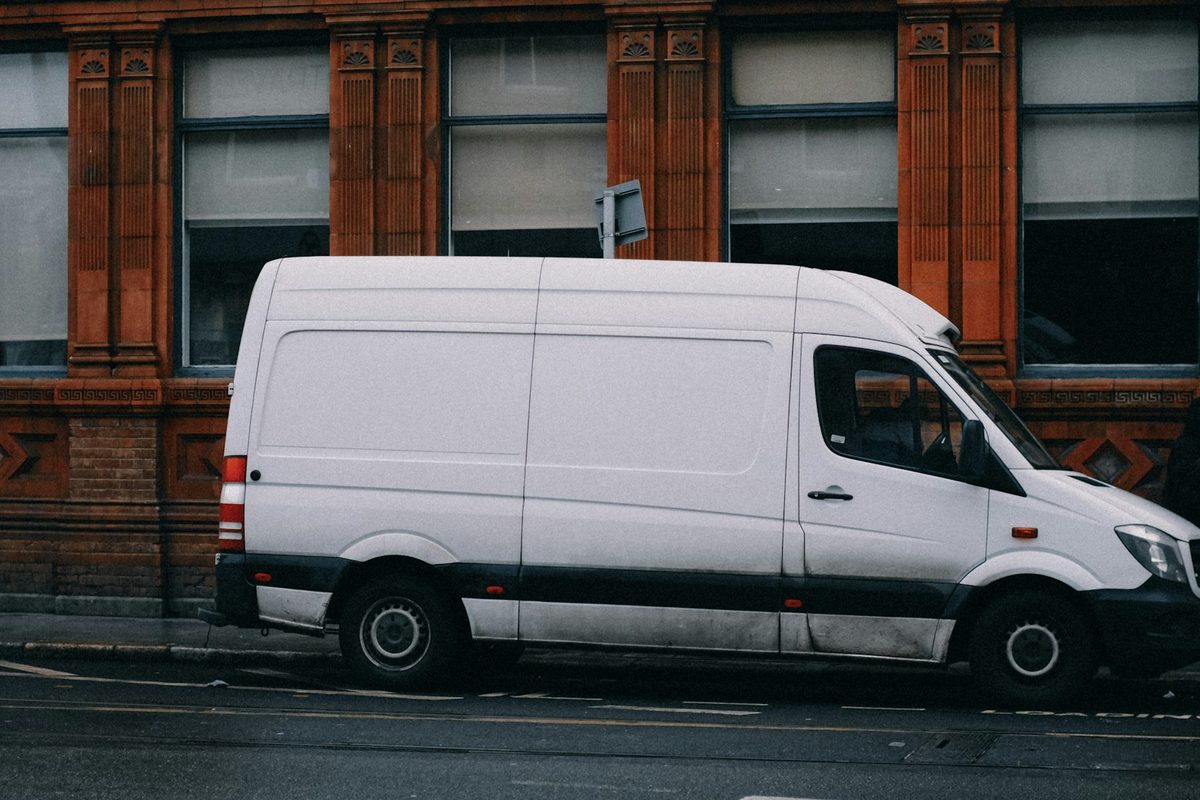 White work van parked on a city street