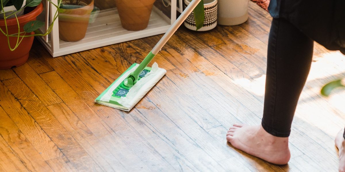 Cleaning a wood floor with a flat mop